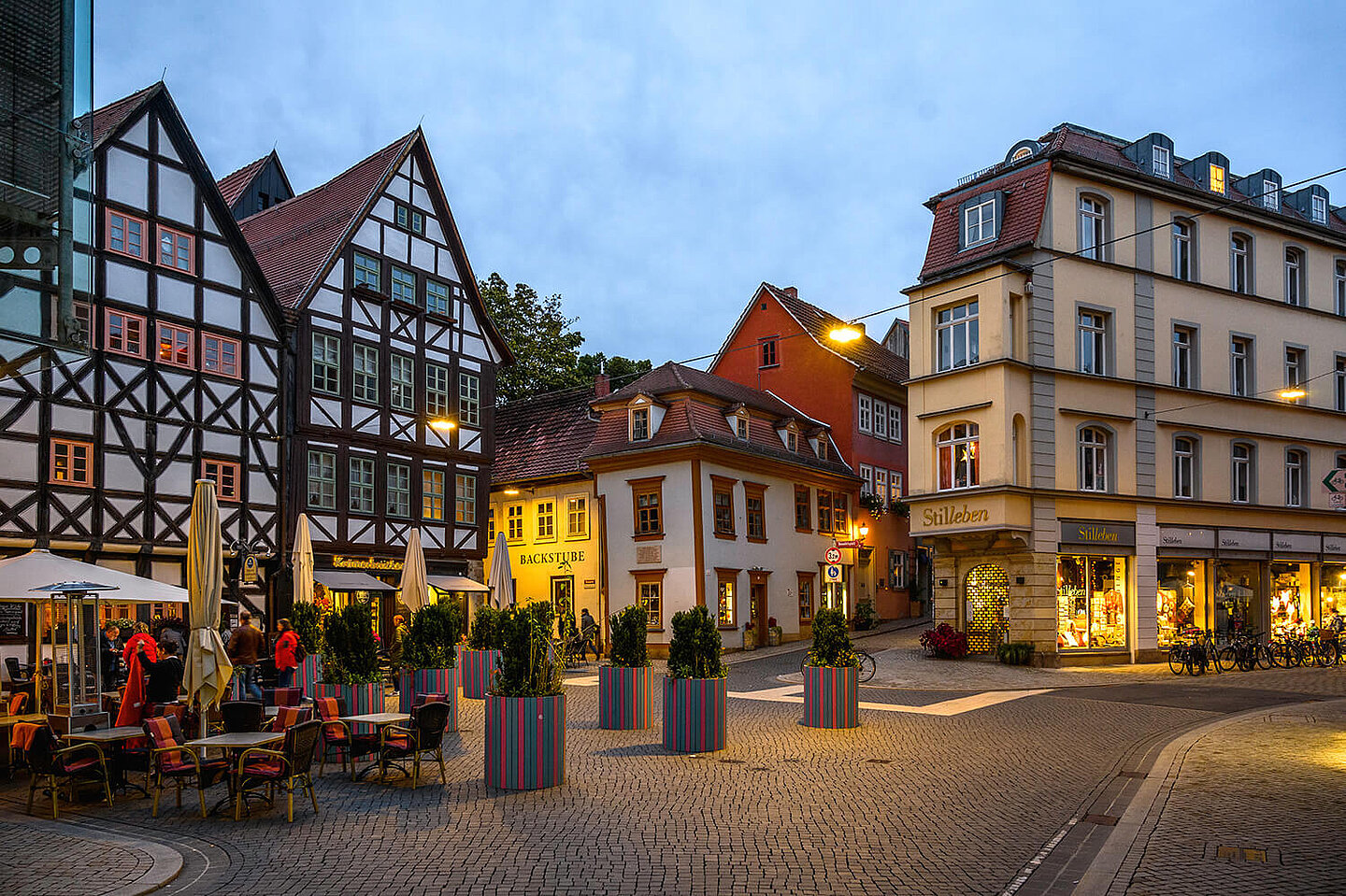 Several old houses at the entrance to the Krämerbrücke in the twilight in the light of the lanterns
